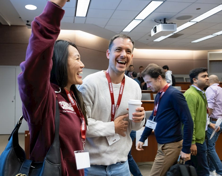 Two students participate in a scavenger hunt during Kick-Off Week for EMBA students at Chicago Booth.